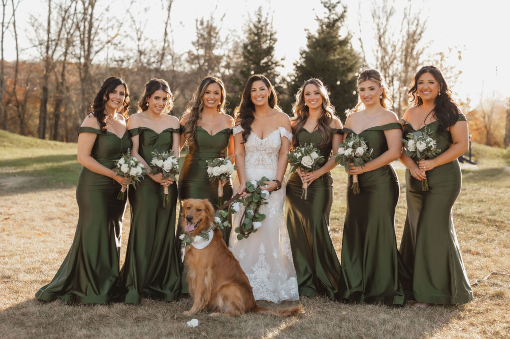 Bridal party photo with golden retriever dog and a greenery leash.